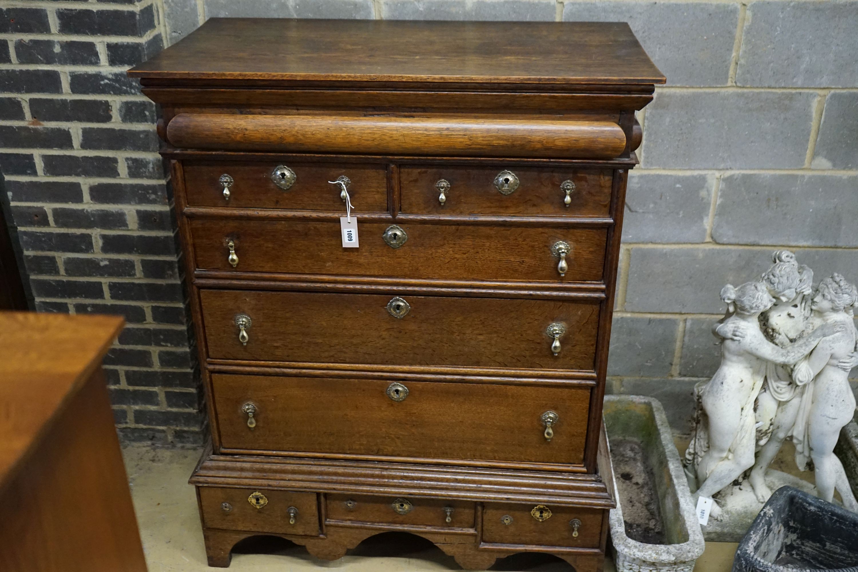 An 18th century oak chest on stand, width 104cm, depth 56cm, height 133cm